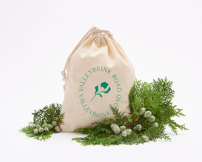 The Winter Tea Ritual presented in a Valleybrink Road muslin gift bag with winter greenery