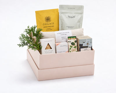 Signature Spa Ritual Gift Box: an Orgaid vitamin C organic sheet mask, Merigold Calendula & Clay Bath Soak, a lavender sage eye pillow, a Nash & Jones silk sea sponge, Palermo rose geranium and mandarin soap, a floral matchbox and The Quiet Botanist 426 mini candle with holiday greenery