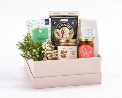 The California Pantry Gift Box: Marmalade Grove strawberry Meyer lemon fruit spread, Little Apple Treats caramels, Joon pistachios, Samovar Moorish Mint tea and McEvoy Ranch orange blossom honey with greenery