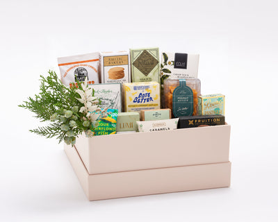 Premier Sweet Gift Box: thirteen artisan sweets including Rustic Bakery vanilla cookies, Ritual, Dick Taylor and Eclat chocolate, Leone anise pastilles, Claeys root beer candies, Date Better baklava dates, Fruition peanut butter cups and Lumi caramels, with holiday greenery