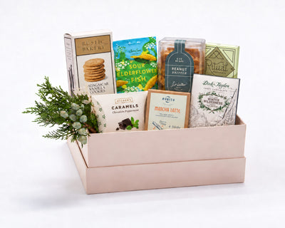 Signature Sweet Gift Box: Rustic Bakery Madagascar vanilla cookies, BonBon sour elderflower fish, Sir Walter Candy Co. peanut brittle, Ritual chocolate, McCrea's chocolate peppermint caramels, Morito matcha latte chocolate and Dick Taylor Winter Wilderness chocolate with holiday greenery