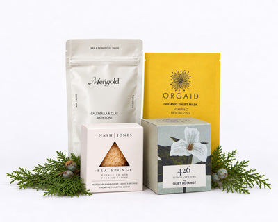 The Unwind: Merigold Calendula & Clay Bath Soak, an Orgaid vitamin C organic sheet mask, a Nash & Jones silk sea sponge and The Quiet Botanist 426 mini candle