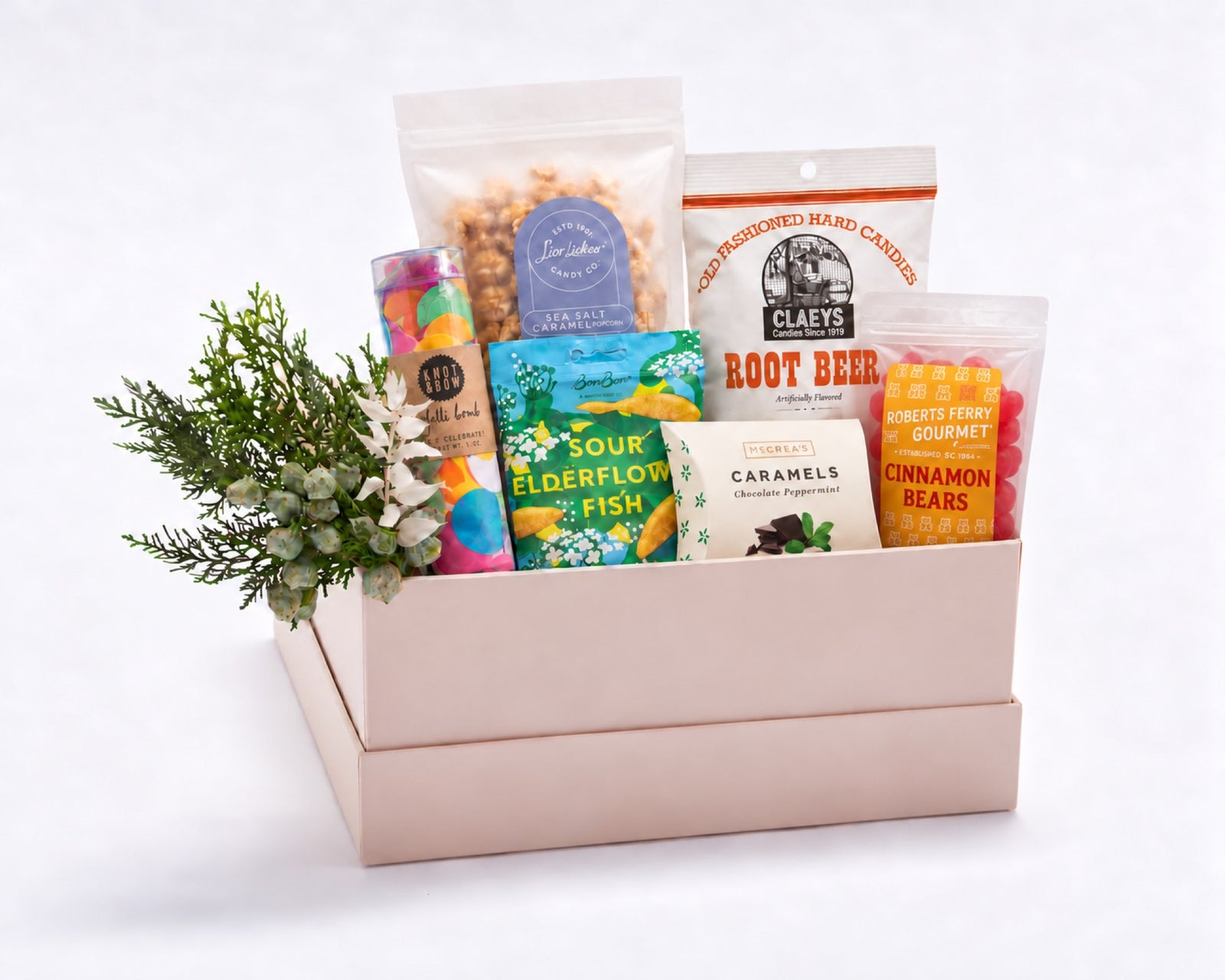 Celebration Gift Box: Knot & Bow confetti bomb, BonBon sour elderflower fish, Sir Walter caramel popcorn, Claeys root beer candies, McCrea's caramels, Roberts Ferry cinnamon bears and greenery in a blush gift box