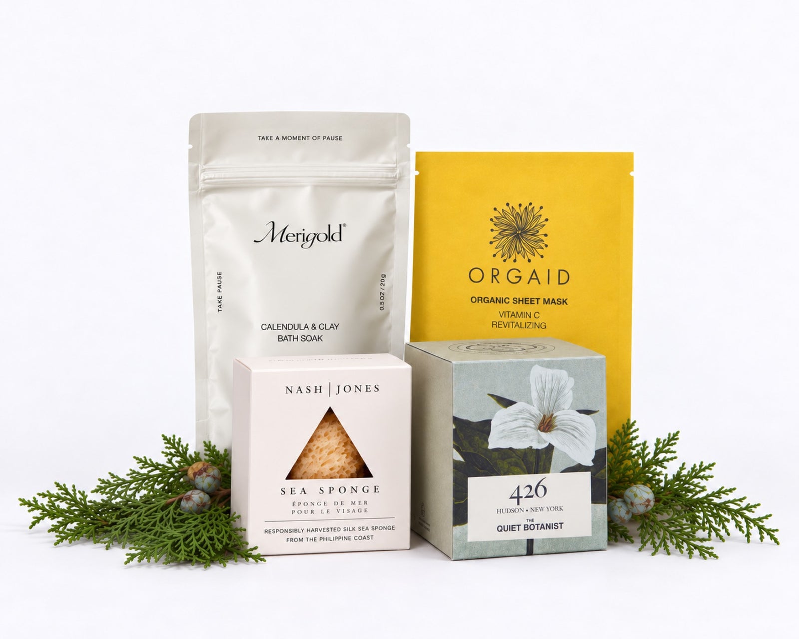 The Unwind: Merigold Calendula & Clay Bath Soak, an Orgaid vitamin C organic sheet mask, a Nash & Jones silk sea sponge and The Quiet Botanist 426 mini candle