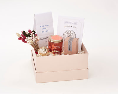 Condolence and Comfort Gift Box with tea, honey, a candle, cookies, and a tea strainer.