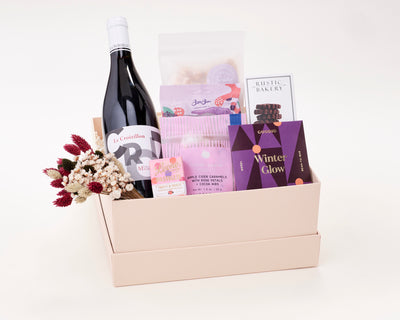 Sweet Treats and Wine Gift Box with Rustic Bakery Cookies, Goodio Winter Glow Chocolate, Little Apple Treats Caramels, Leone Pastiglie Hard Candies, BonBon NYC gummies, and Sir Walter Candy Co. Popcorn.